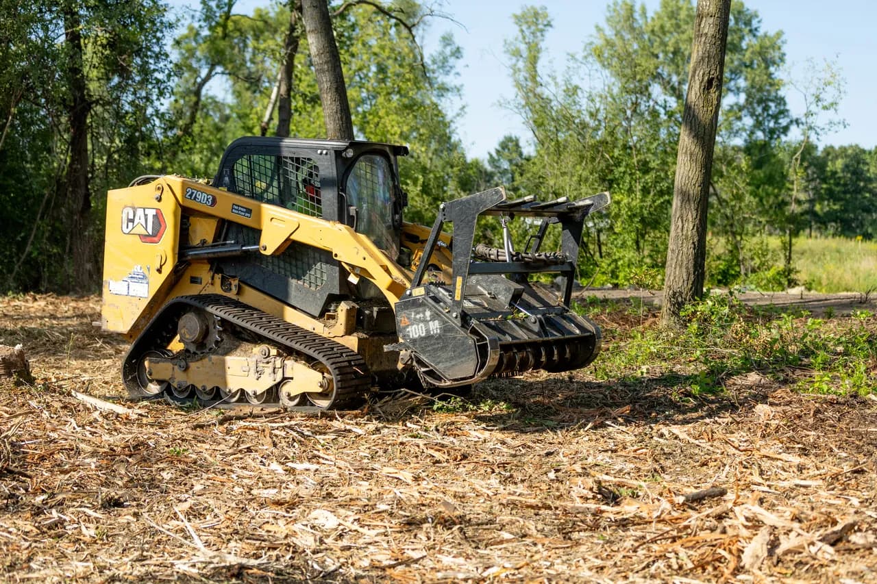 Cat 275 XE compact track loader on a freshly mulched site, ready for seed