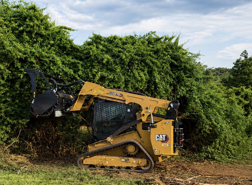 Forestry mulching machine clearing overgrown fence line on rural Loudoun County property